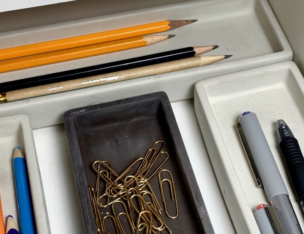 Concrete pen tray with pencils, pens and gold paper clips, modern home decor